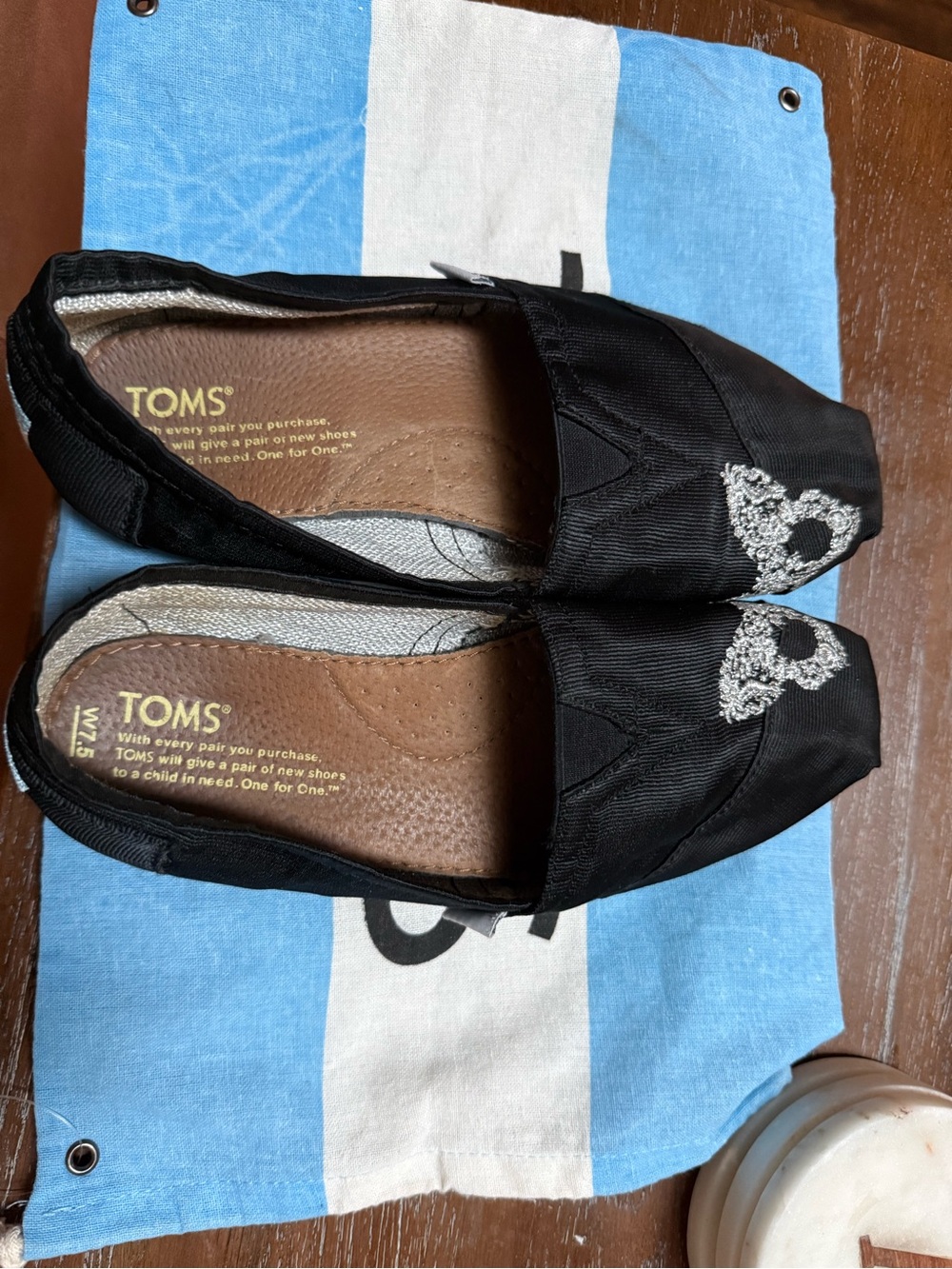 TOMS Black Slip-On Flats with Silver  Butterfly Embroidery